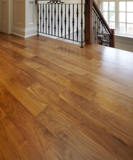 A wooden floor with a railing and a window