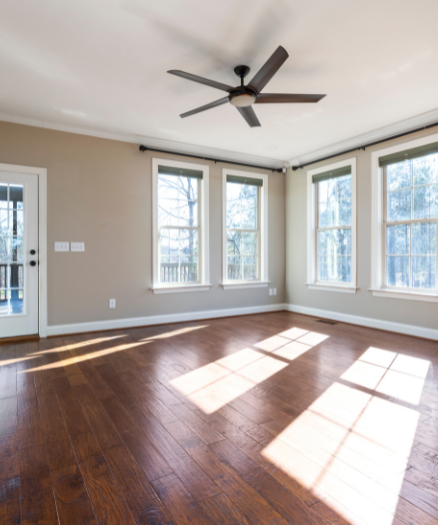 A large empty room with a ceiling fan